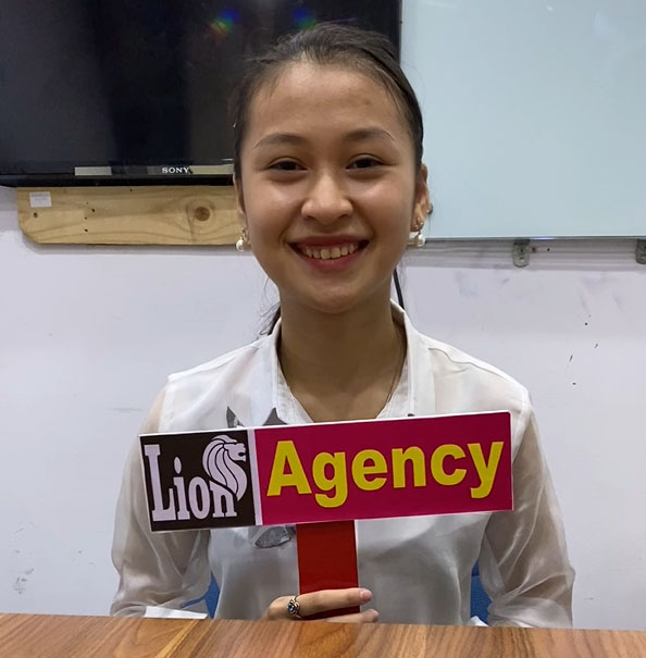 kl escort girl holding up a sign that says lion agency.