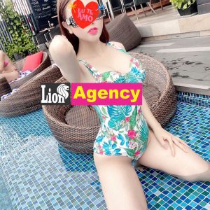A woman in a bikini sitting by a pool with Product Name 285 in Kuala Lumpur.