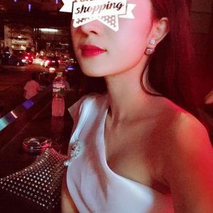 A woman in a white dress adorned with a star on her face, offering 799 services in KL.