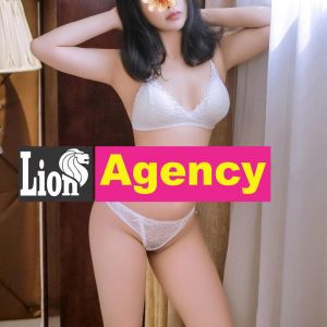 A seductive woman in lingerie posing in front of a window portraying the allure of a 316 escort.