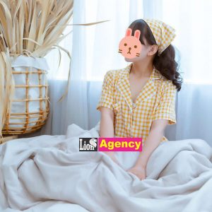 A woman in a vibrant yellow dress gracefully reclining on a cozy 707.