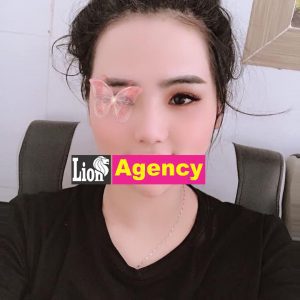 A klescort woman with a butterfly tattoo on her face.