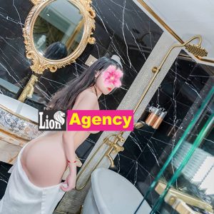 A woman in a bathing suit, serving as a Kuala Lumpur escort girl, standing in front of 724 mirror.