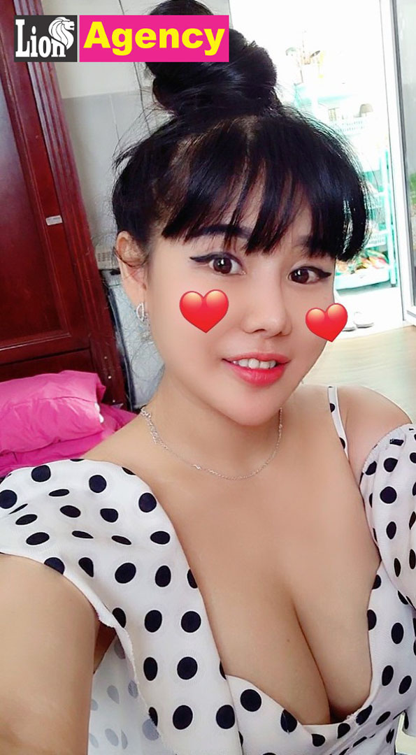 A 407 escort girl in a polka dot dress is taking a selfie.