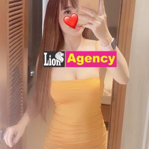 A woman in a yellow dress capturing a 681 reflection in a mirror.