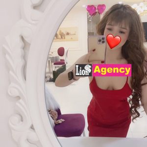 A woman in a red dress posing for a selfie in front of a mirror, capturing her stylish outlook as a 681 escort.